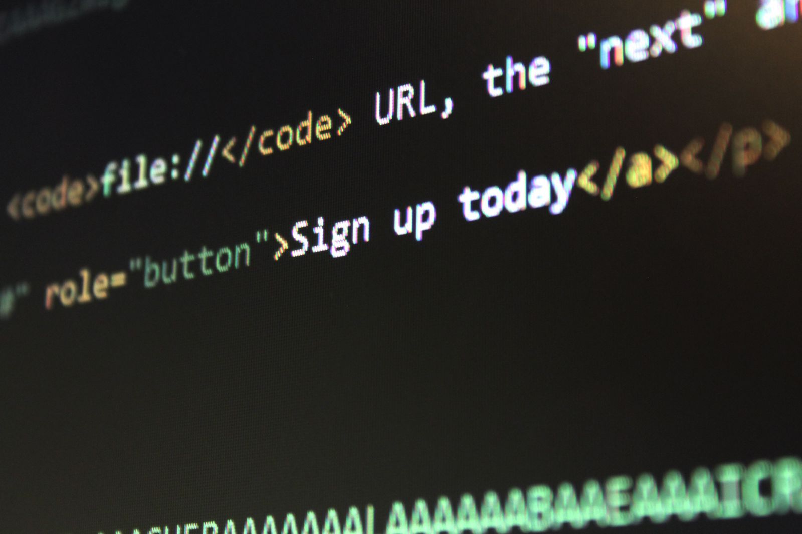 HTML and CSS source code on a screen, representing reusable components in a design system