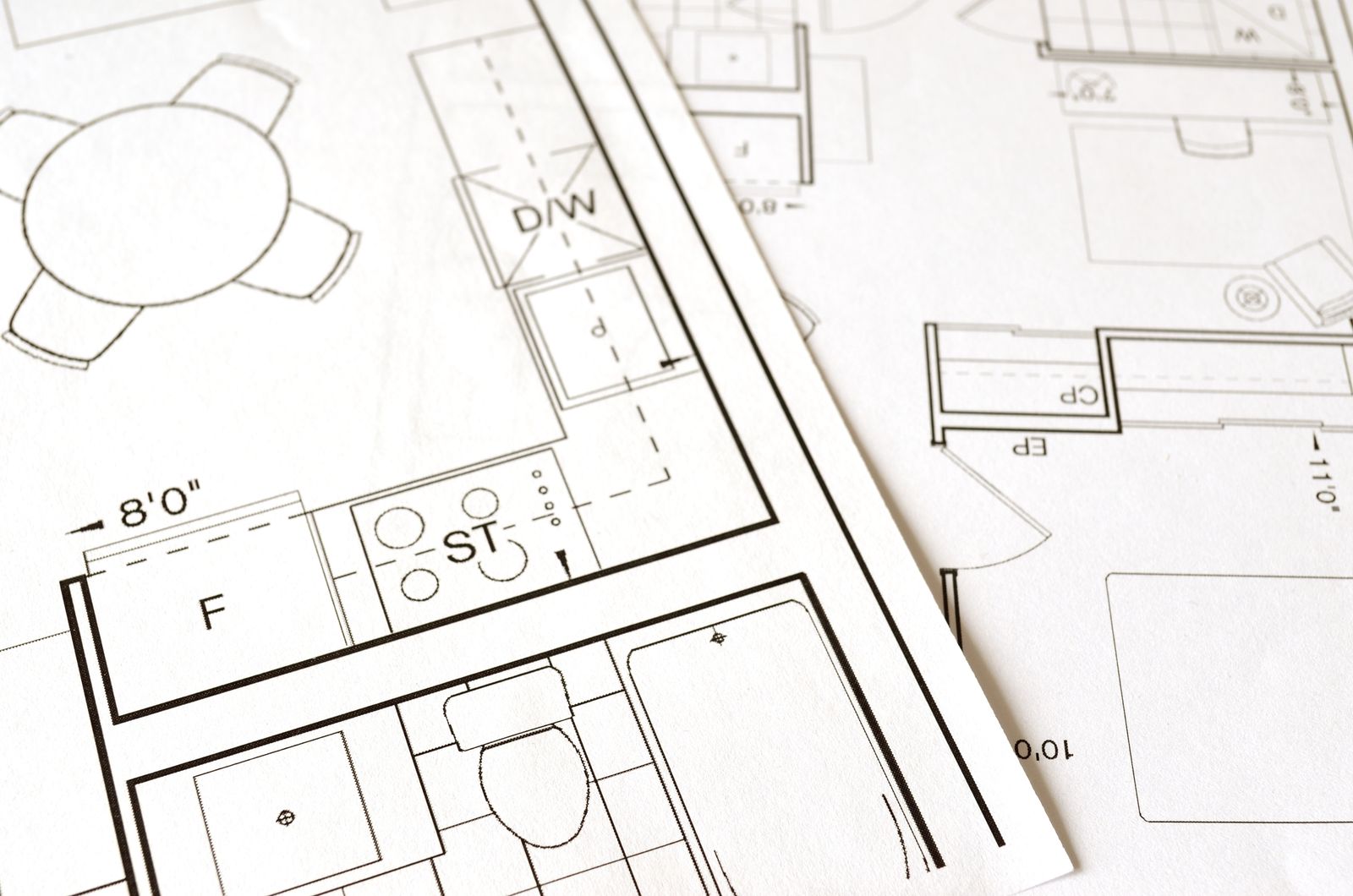 Detailed architectural floor plan on paper, a blueprint metaphor for the UI/UX architect role