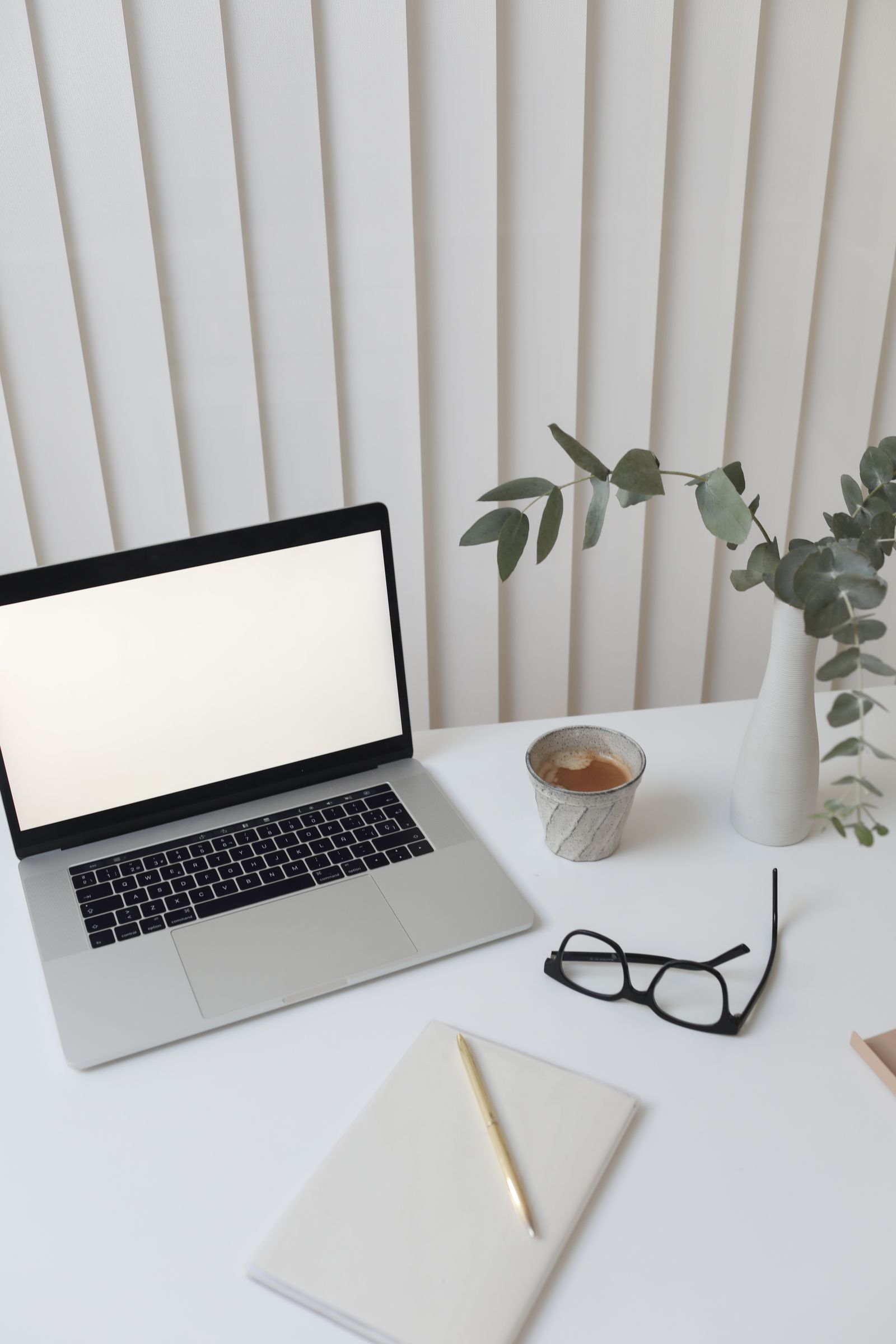 Creative workplace with a laptop and notebook, representing the UI designer's toolkit