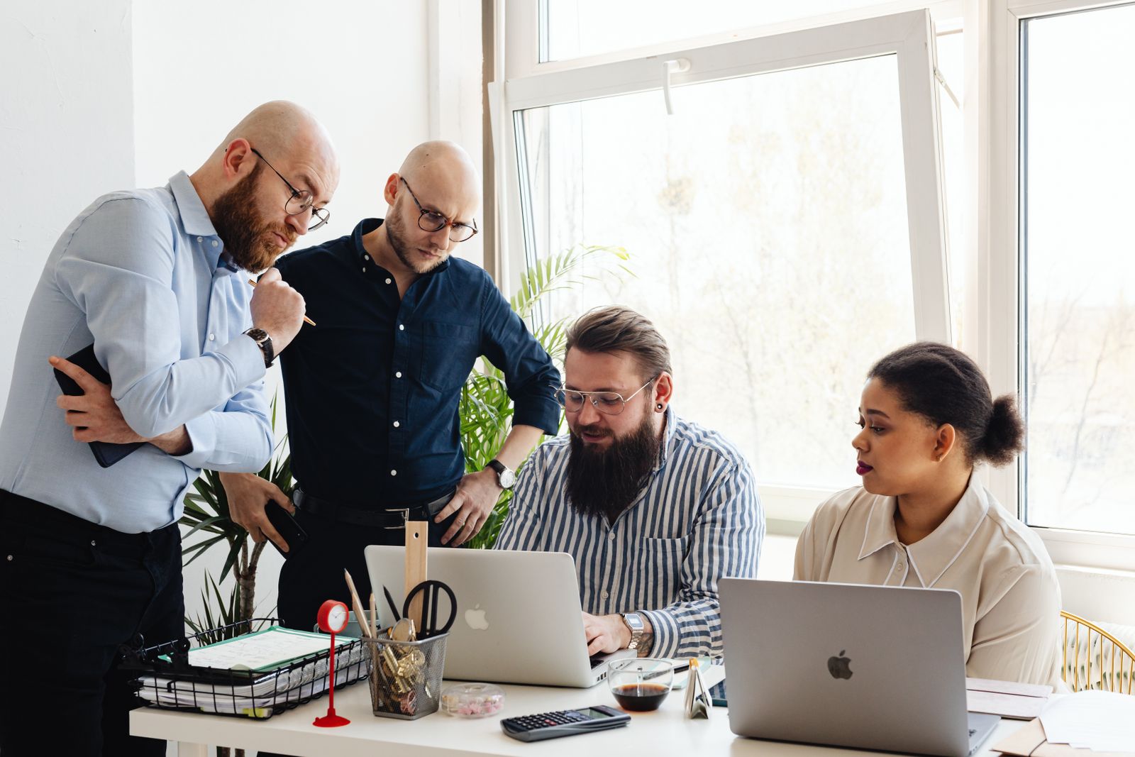 Diverse professionals collaborating in a modern office, reflecting user-first design principles